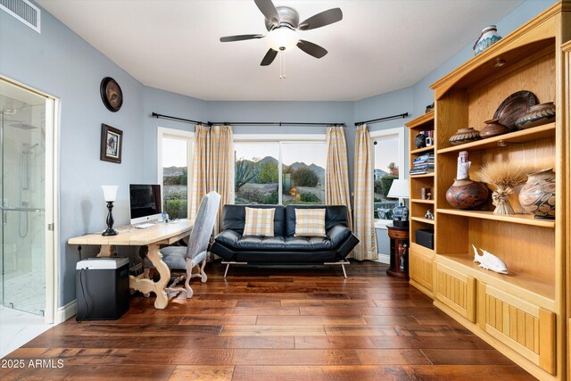 office featuring visible vents, dark wood finished floors, baseboards, and ceiling fan