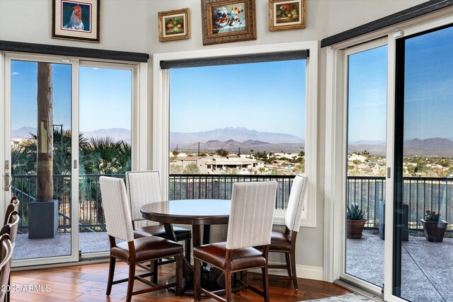 sunroom featuring a healthy amount of sunlight and a mountain view