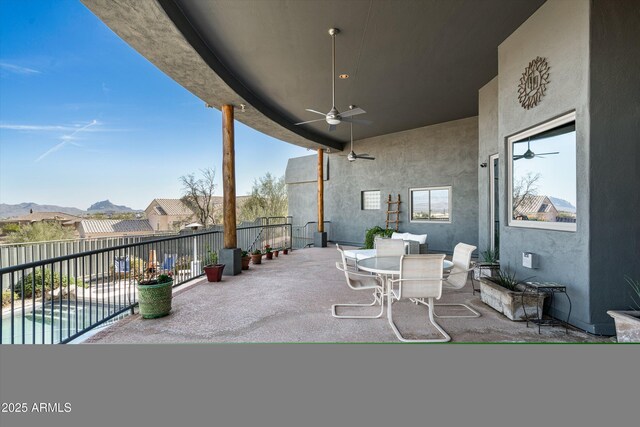 view of patio / terrace featuring a fenced in pool, fence, outdoor dining area, and a ceiling fan