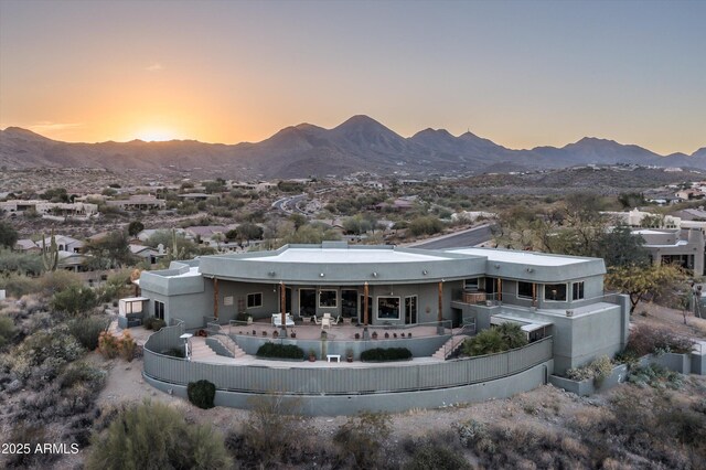 rear view of property with a patio, fence, a mountain view, and an outdoor pool