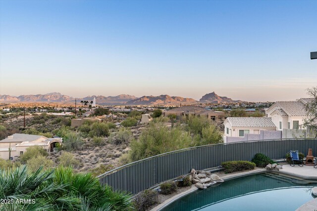 view of swimming pool with fence, a mountain view, and a fenced in pool