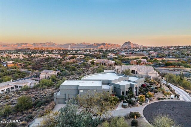 aerial view at dusk featuring a residential view and a mountain view