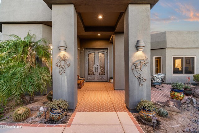 entrance to property with stucco siding