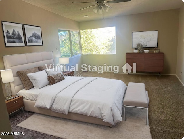 bedroom with ceiling fan and dark colored carpet