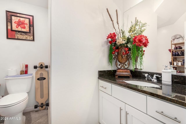 bathroom featuring tile patterned flooring, vanity, and toilet