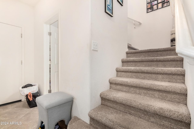 staircase with tile patterned flooring