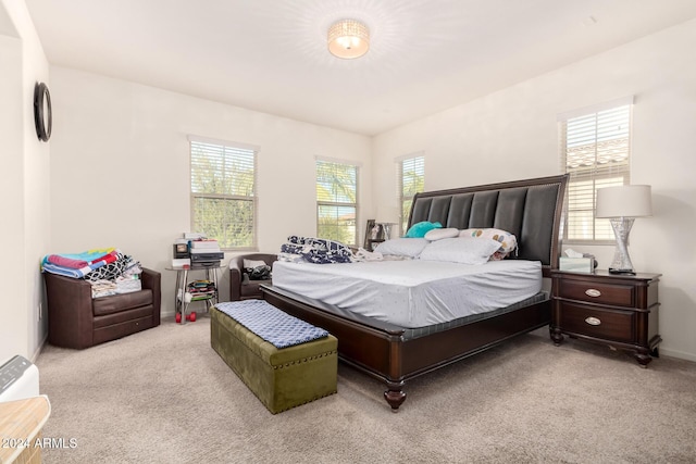 bedroom featuring light carpet