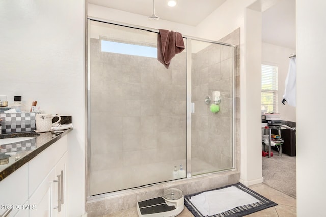 bathroom with tile patterned floors, a shower with shower door, and sink