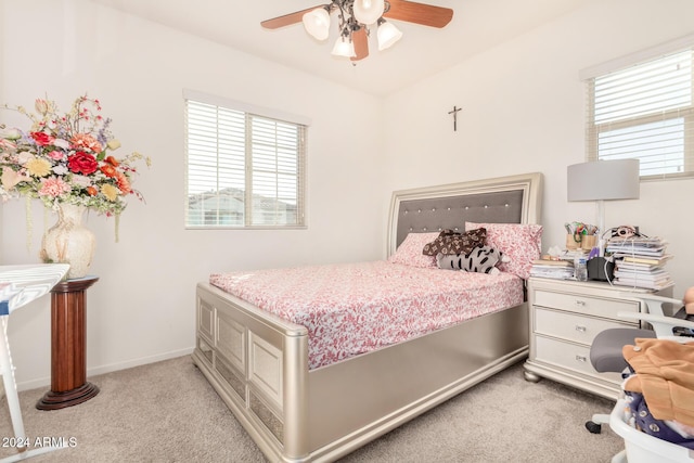 bedroom with ceiling fan and light colored carpet