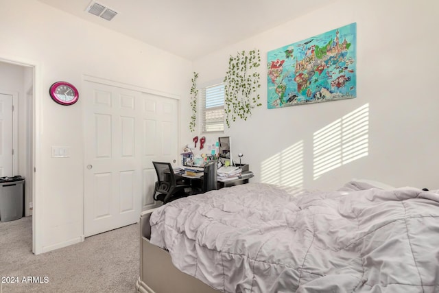 bedroom featuring a closet and light colored carpet