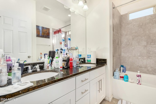 bathroom featuring shower / bath combo with shower curtain and vanity