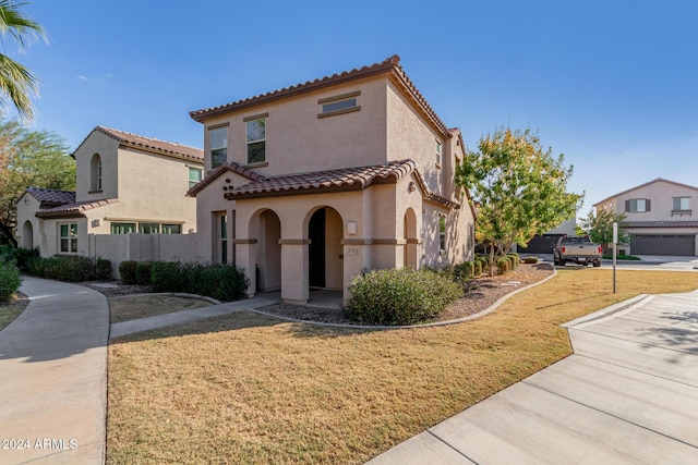 mediterranean / spanish house with a front yard