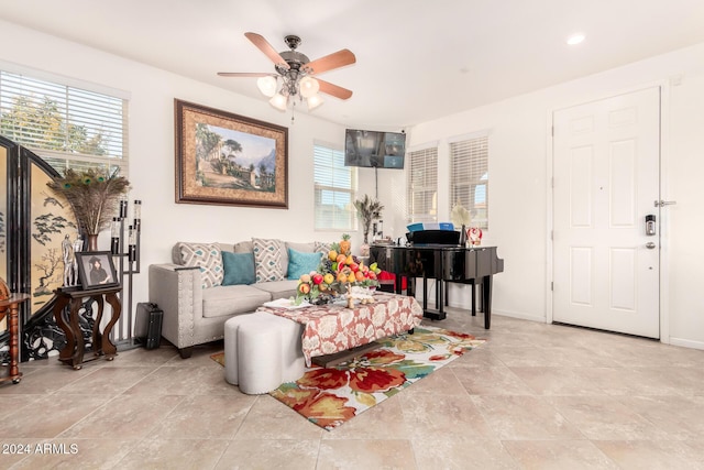 living room featuring ceiling fan and a healthy amount of sunlight