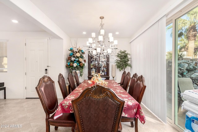 dining area featuring light tile patterned floors and a notable chandelier