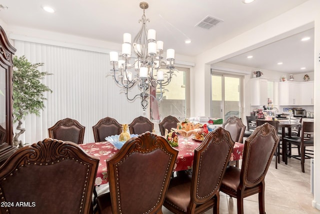 tiled dining space featuring a chandelier