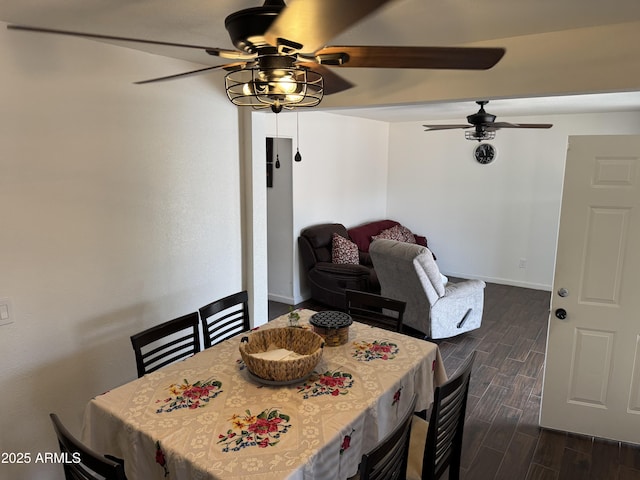 dining room with wood finish floors, ceiling fan, and baseboards