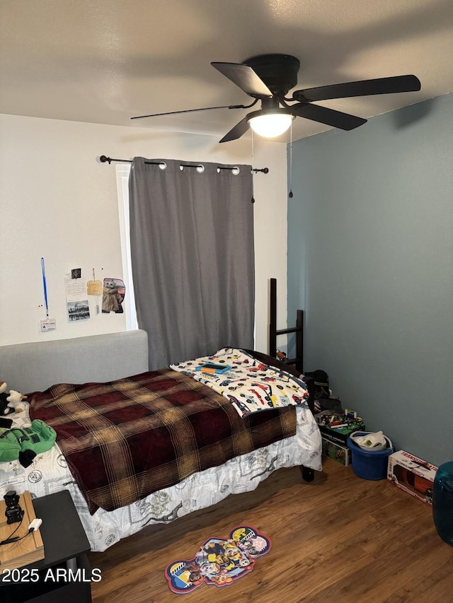bedroom featuring a ceiling fan and wood finished floors