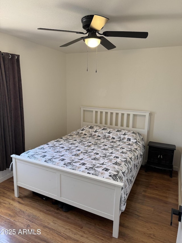 bedroom featuring wood finished floors and a ceiling fan