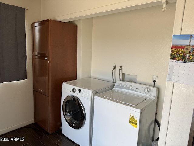 washroom featuring dark wood-type flooring, separate washer and dryer, laundry area, and baseboards