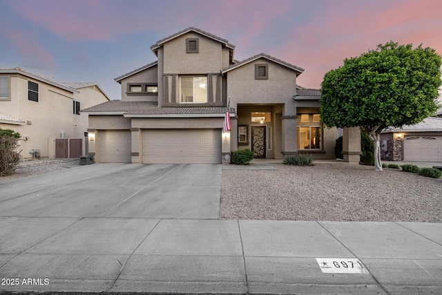 6971 W El Cortez Pl, Peoria, AZ 85383 - traditional home featuring stucco siding, a tile roof, a garage, and driveway