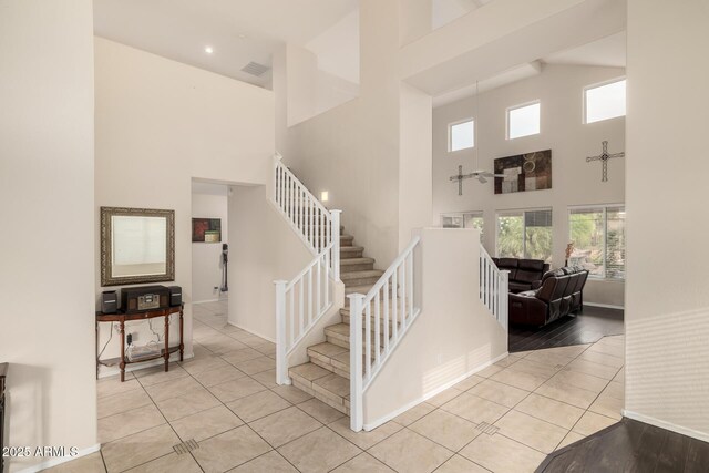 6971 W El Cortez Pl, Peoria, AZ 85383 - stairway featuring high vaulted ceiling, tile patterned floors, baseboards, and recessed lighting