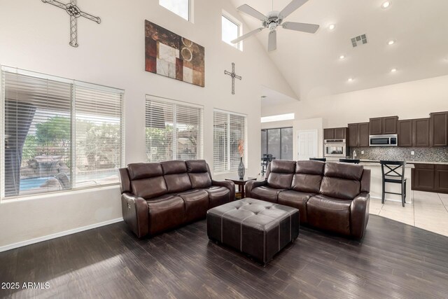 6971 W El Cortez Pl, Peoria, AZ 85383 - living room with high vaulted ceiling, ceiling fan, baseboards, light wood-type flooring, and recessed lighting