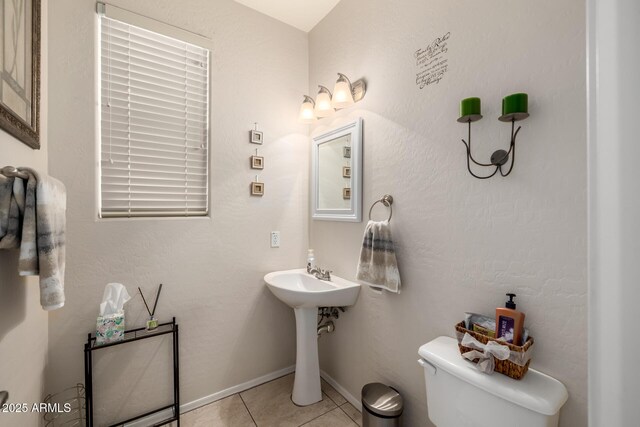 6971 W El Cortez Pl, Peoria, AZ 85383 - half bathroom featuring toilet, tile patterned flooring, and a sink