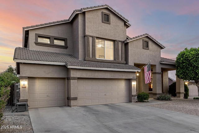 6971 W El Cortez Pl, Peoria, AZ 85383 - view of front of home with a tile roof, an attached garage, stucco siding, and concrete driveway