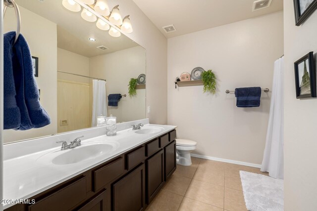 6971 W El Cortez Pl, Peoria, AZ 85383 - full bathroom featuring double vanity, toilet, tile patterned floors, curtained shower, and baseboards