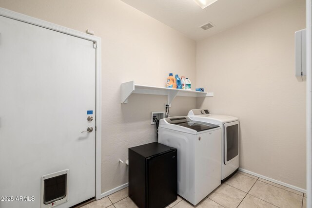 6971 W El Cortez Pl, Peoria, AZ 85383 - laundry area featuring independent washer and dryer, baseboards, light tile patterned floors, and heating unit