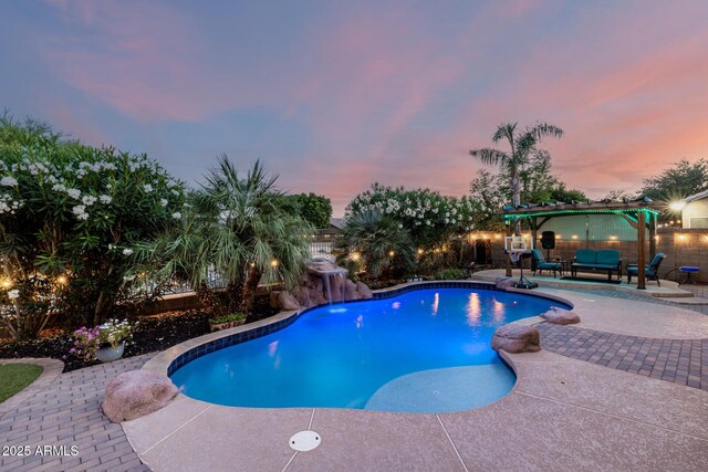 6971 W El Cortez Pl, Peoria, AZ 85383 - pool at dusk featuring a patio area, a fenced backyard, and outdoor lounge area