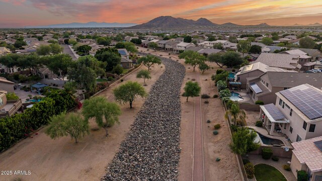 6971 W El Cortez Pl, Peoria, AZ 85383 - aerial overview of property's location with nearby suburban area and a mountain backdrop