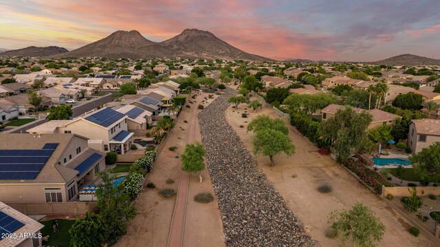 6971 W El Cortez Pl, Peoria, AZ 85383 - aerial view at dusk of view of pool area, a mountain view, and a residential view