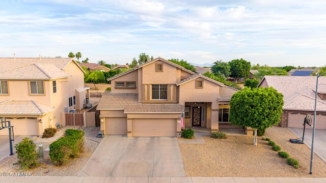 6971 W El Cortez Pl, Peoria, AZ 85383 - view of front of home featuring a tiled roof, stucco siding, a garage, and driveway