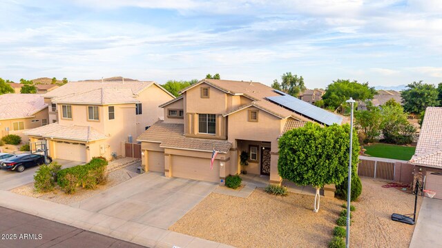 6971 W El Cortez Pl, Peoria, AZ 85383 - traditional-style home with an attached garage, stucco siding, solar panels, driveway, and a tiled roof