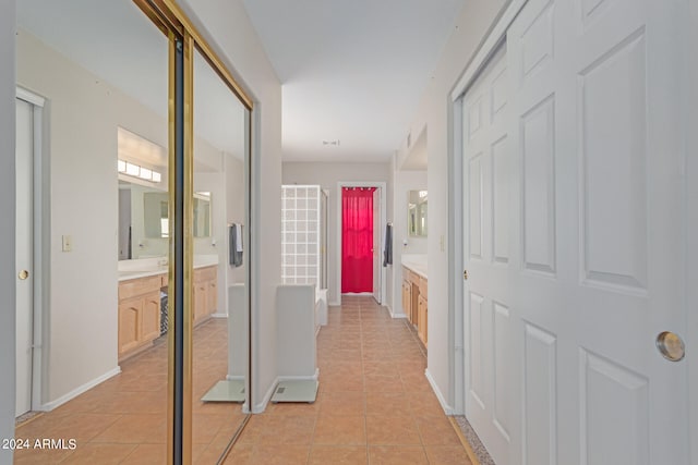 hall featuring light tile patterned floors