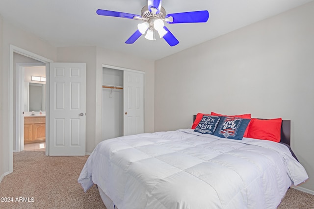 carpeted bedroom featuring a closet, ceiling fan, and ensuite bathroom