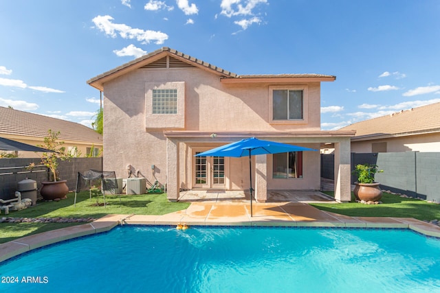 back of property featuring a fenced in pool, a patio area, and cooling unit