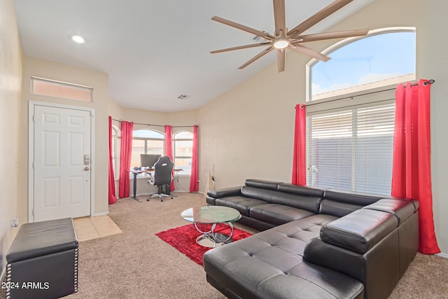 living room featuring ceiling fan, a wealth of natural light, light colored carpet, and vaulted ceiling