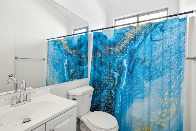 bathroom with toilet, vanity, and a shower with shower curtain