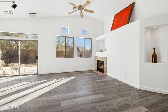 unfurnished living room with dark wood-style flooring, visible vents, ceiling fan, and a tiled fireplace