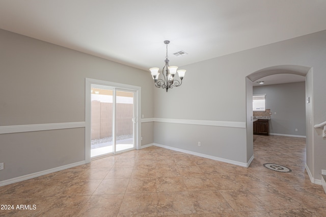 empty room with a notable chandelier