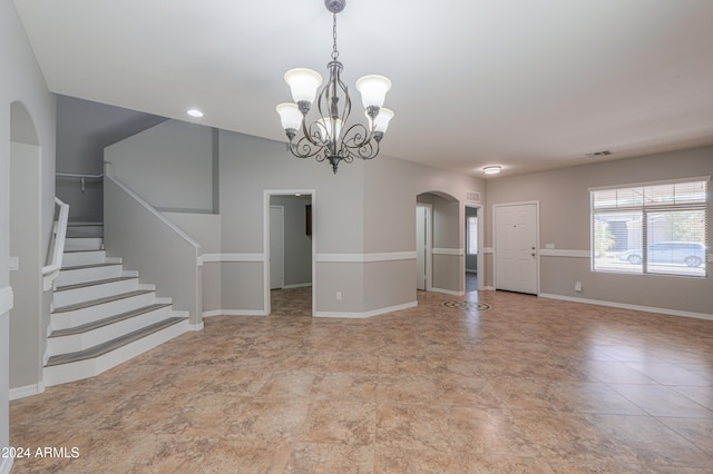 spare room with a notable chandelier