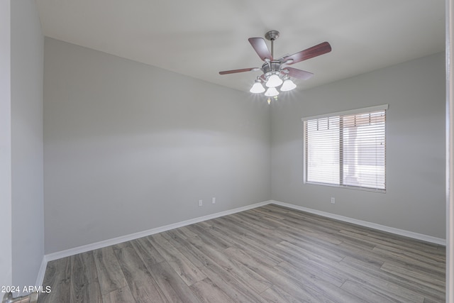 spare room featuring light wood-type flooring and ceiling fan