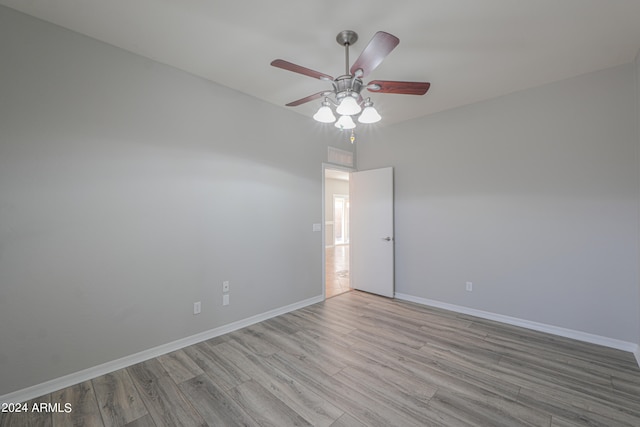 empty room with ceiling fan and light hardwood / wood-style floors