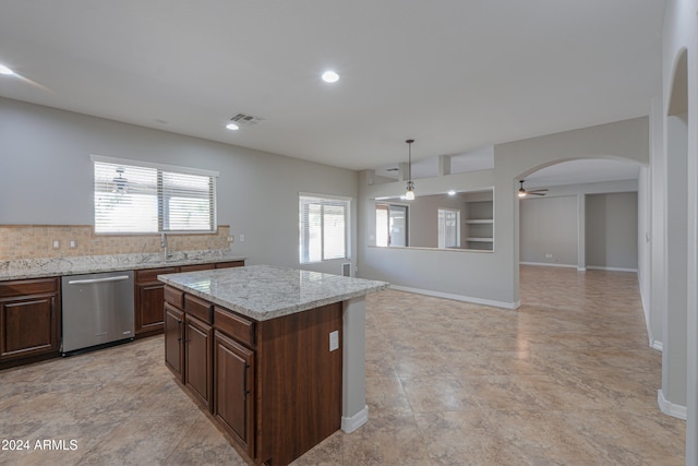 kitchen with ceiling fan, a center island, tasteful backsplash, decorative light fixtures, and dishwasher