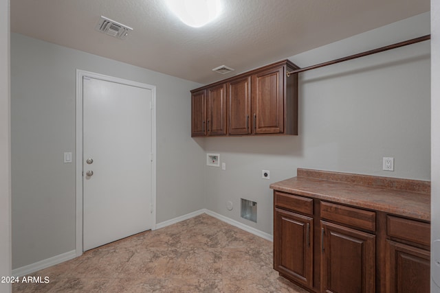 washroom featuring hookup for an electric dryer, hookup for a washing machine, cabinets, and a textured ceiling