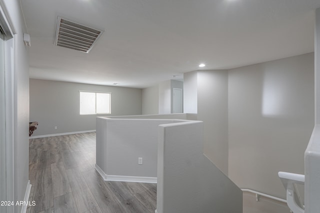 corridor with light hardwood / wood-style floors