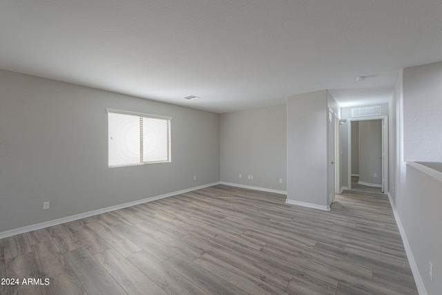 empty room with light hardwood / wood-style flooring