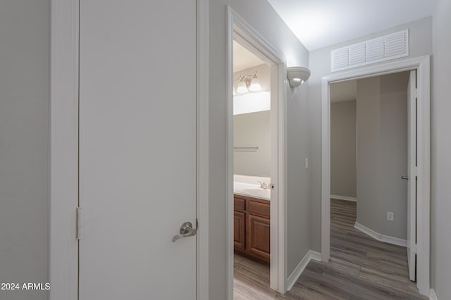 hall featuring sink and hardwood / wood-style floors